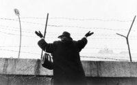 Woman waving over the Berlin Wall in 1961